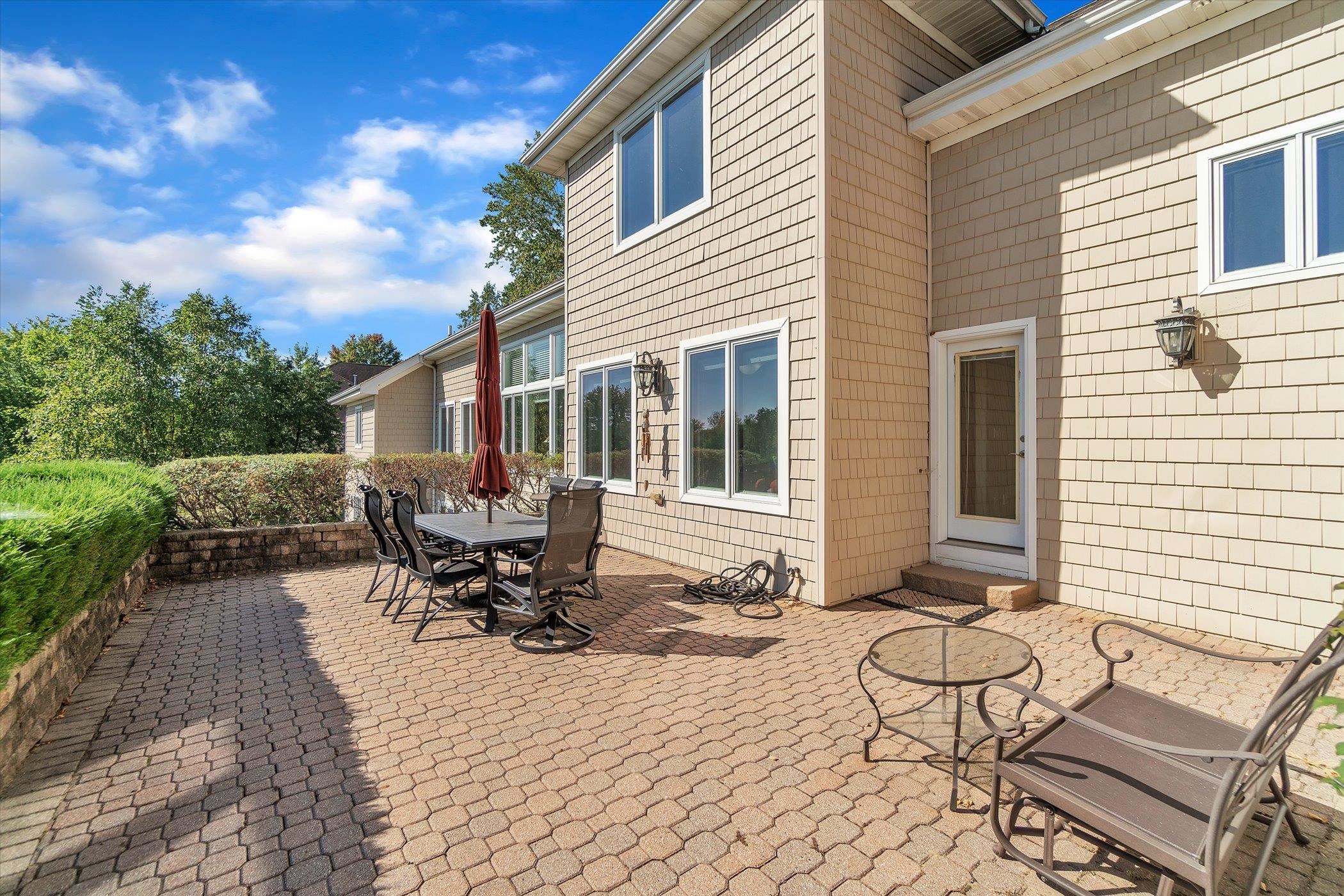 12535 Bellingham Road Caledonia, IL 61011 - Photo 48 of 57 a view of a patio with table and chairs with wooden fence and plants