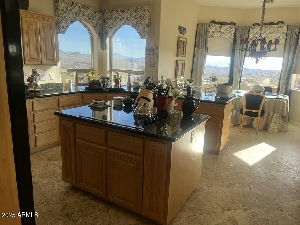 11519 East Blue Wash Road Scottsdale, AZ 85262 - Photo 2 of 42 a kitchen with stainless steel appliances granite countertop a sink a stove and a dining table view