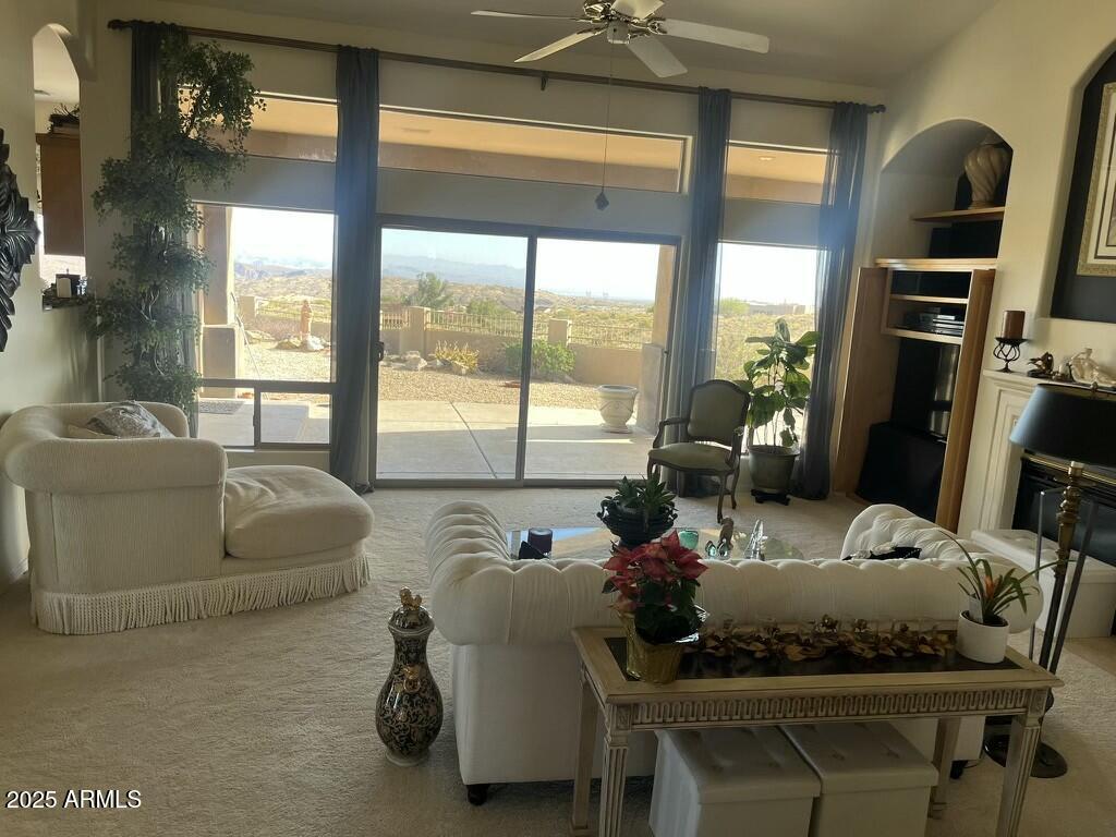 11519 East Blue Wash Road Scottsdale, AZ 85262 - Photo 30 of 42 a living room with furniture and floor to ceiling windows