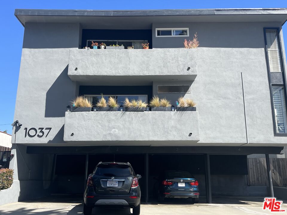 a view of building with car parked