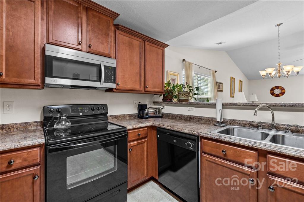 3005 Arthur Road, Unit 170 Indian Land, SC 29707 - Photo 23 of 38 a kitchen with stainless steel appliances granite countertop a sink stove and microwave