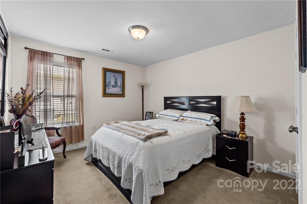 3005 Arthur Road, Unit 170 Indian Land, SC 29707 - Photo 32 of 38 a bedroom with a bed and a couch