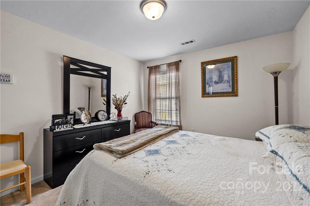 3005 Arthur Road, Unit 170 Indian Land, SC 29707 - Photo 33 of 38 a bedroom with a bed and a lamp on dresser