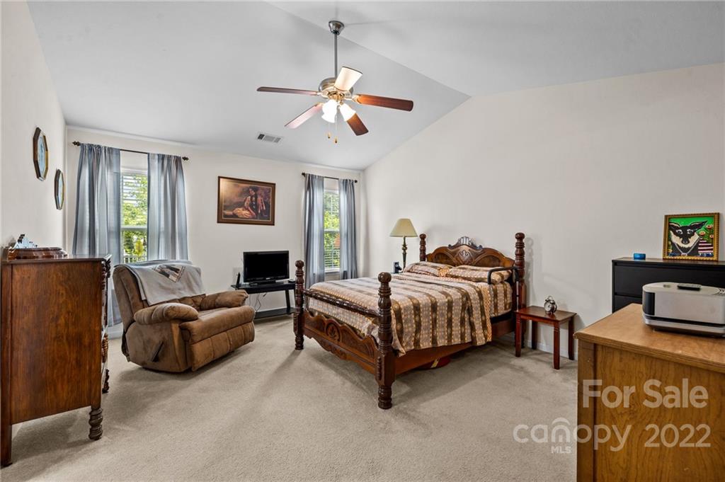 3005 Arthur Road, Unit 170 Indian Land, SC 29707 - Photo 35 of 38 a spacious bedroom with a bed and a couch