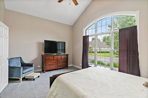 a bedroom with a bed and large window