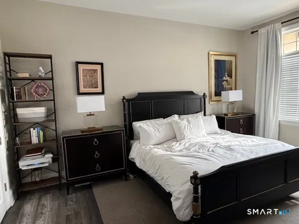 a spacious bedroom with a bed and large windows