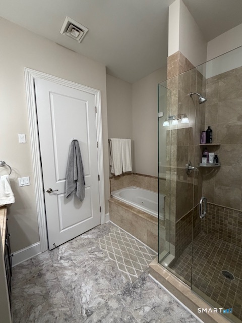 100 Stone Ridge Way, Unit 1H Fairfield, CT 06824 - Photo 20 of 30 a bathroom with a shower and mirror