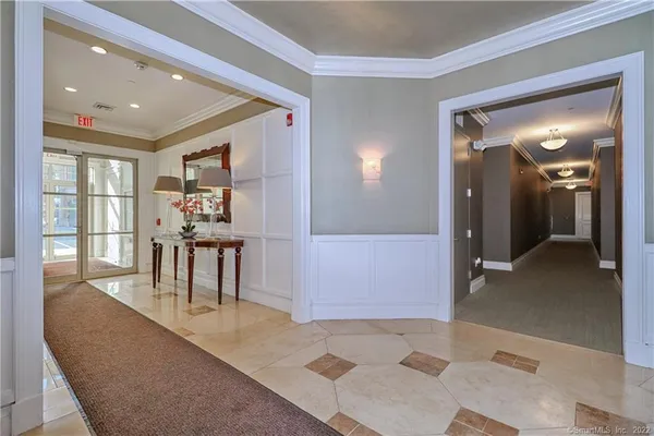a dining room with furniture and a floor to ceiling window