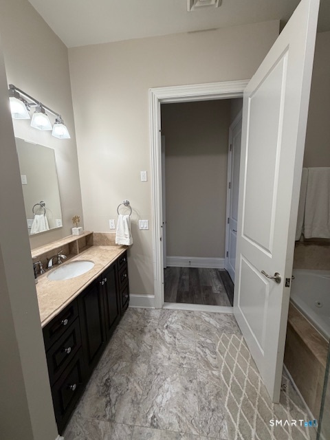 100 Stone Ridge Way, Unit 1H Fairfield, CT 06824 - Photo 21 of 30 a bathroom with a sink and a mirror
