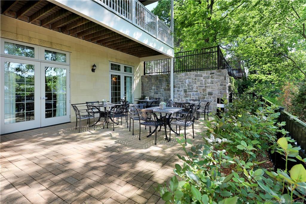 100 Stone Ridge Way, Unit 1H Fairfield, CT 06824 - Photo 29 of 30 a view of a patio with table and chairs and potted plants