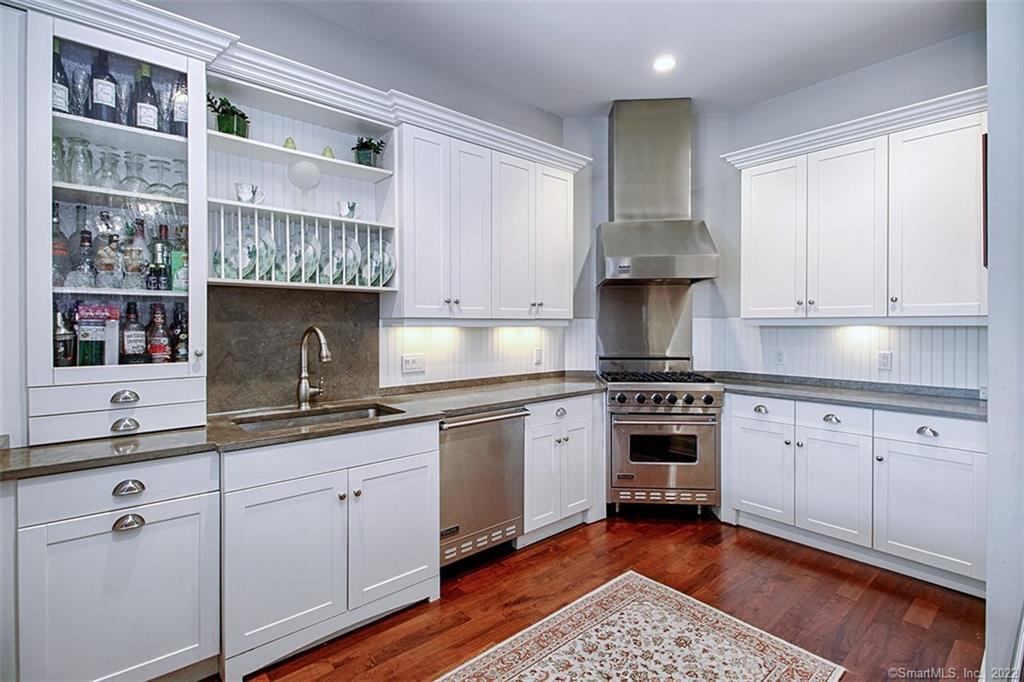 100 Stone Ridge Way, Unit 1H Fairfield, CT 06824 - Photo 3 of 30 a kitchen with stainless steel appliances granite countertop a stove a sink and a microwave
