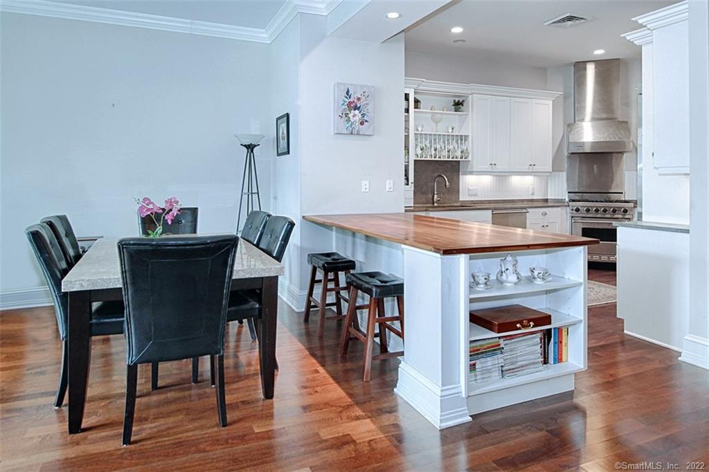 100 Stone Ridge Way, Unit 1H Fairfield, CT 06824 - Photo 6 of 30 a open kitchen with stainless steel appliances granite countertop a stove top oven a sink and cabinets