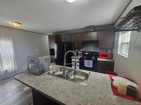a kitchen with sink and refrigerator