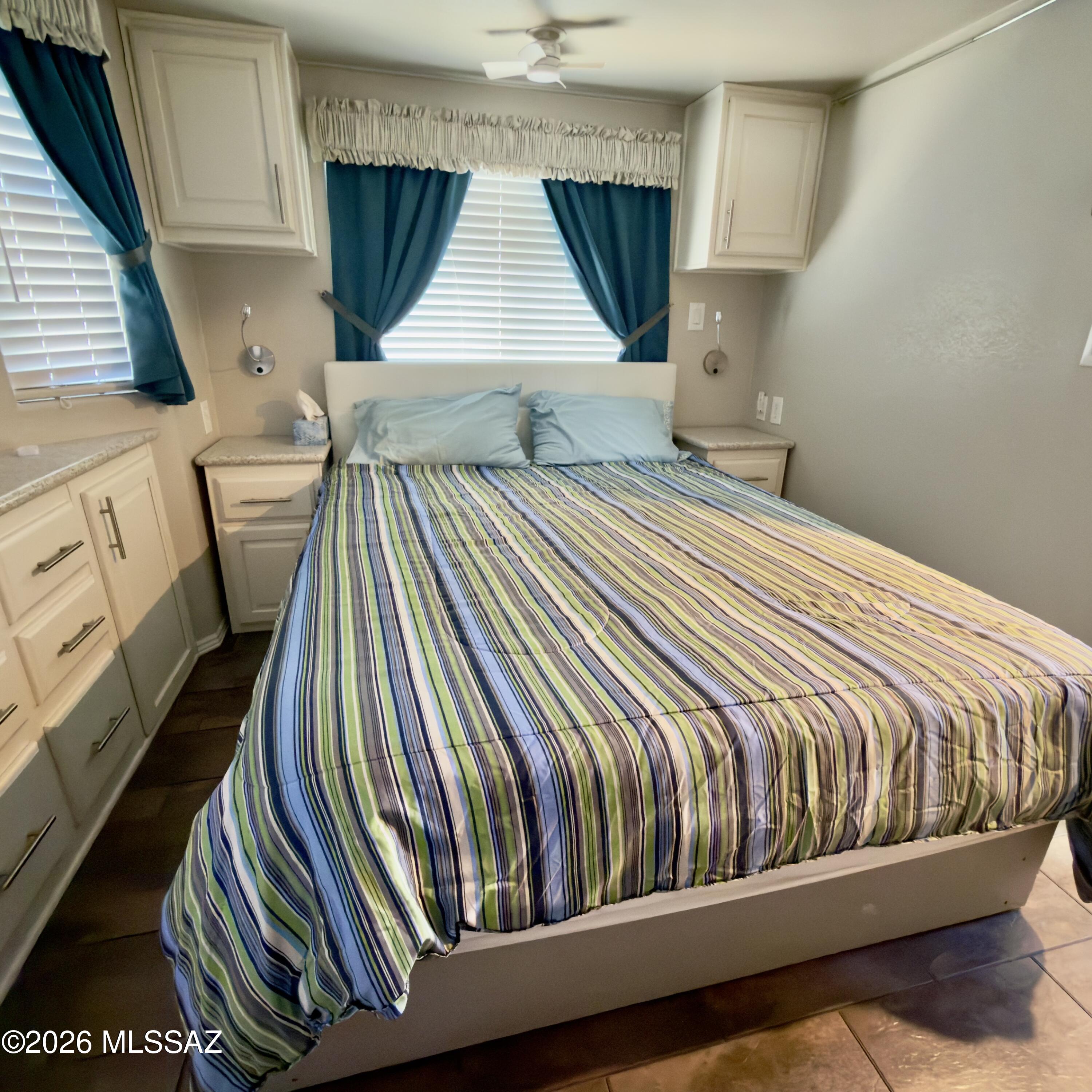 2843 19 Interstate 19 Frontage Road, Unit 116 Amado, AZ 85645 - Photo 14 of 32 a bedroom with a bed and a large window