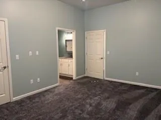 an empty room with closet and mirror