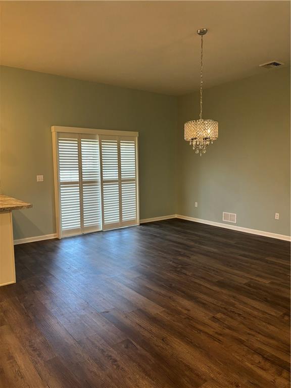 901 Valentina Lane Lower Burrell, PA 15068 - Photo 9 of 25 an empty room with wooden floor chandelier and windows
