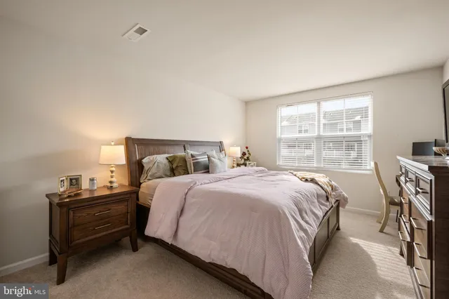 a bedroom with a bed and a table in it