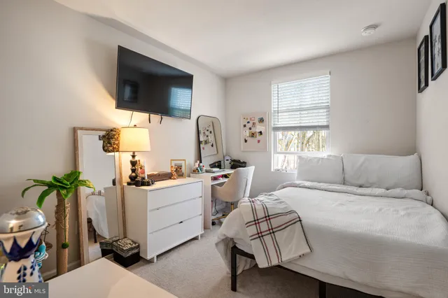 a living room with furniture a flat screen tv and a potted plant