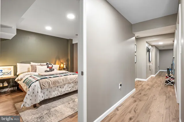 a bedroom with a bed and a large mirror