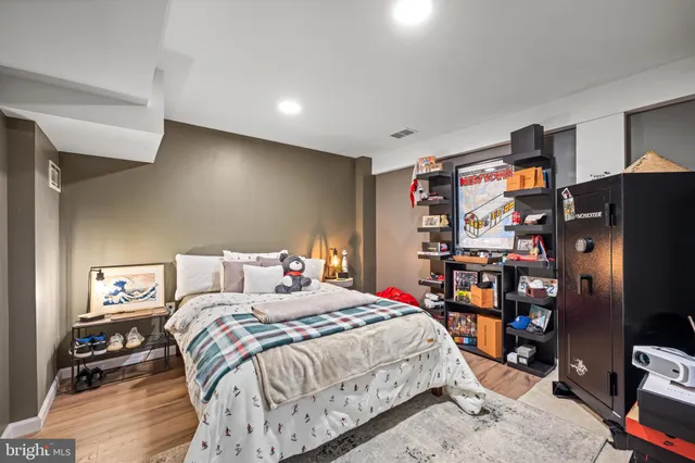 a bed room with a bed and a refrigerator