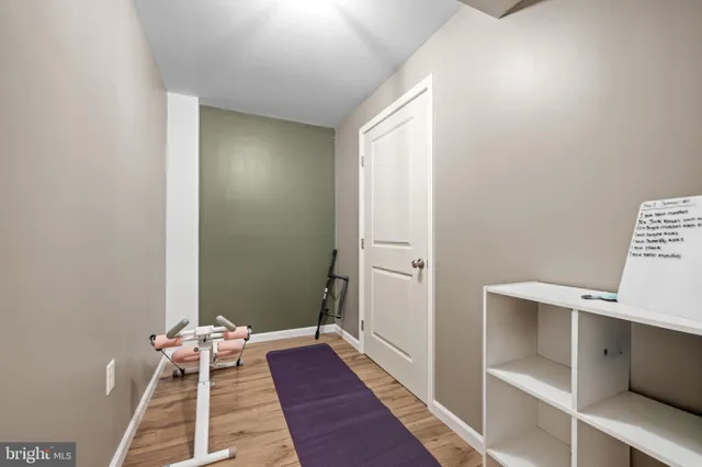 a room with a bed and wooden floor