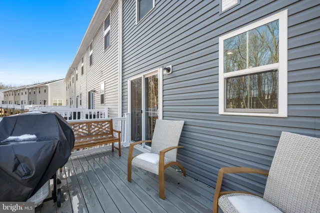 a balcony with wooden floor and furniture