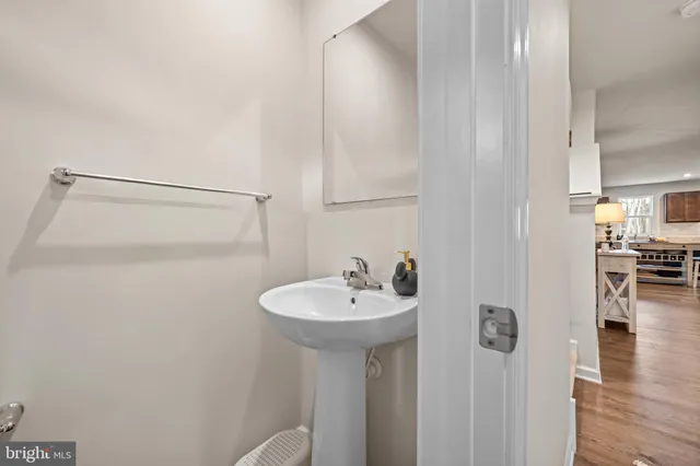 a bathroom with a sink a mirror and a shower