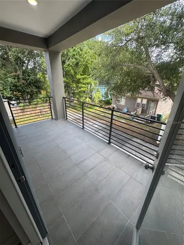 a view of a room with wooden floor and iron stairs
