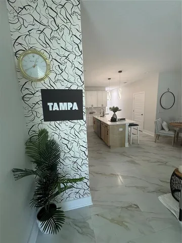 a living room with furniture and a painting on the wall