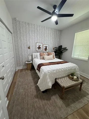 a bedroom with a bed and a chandelier