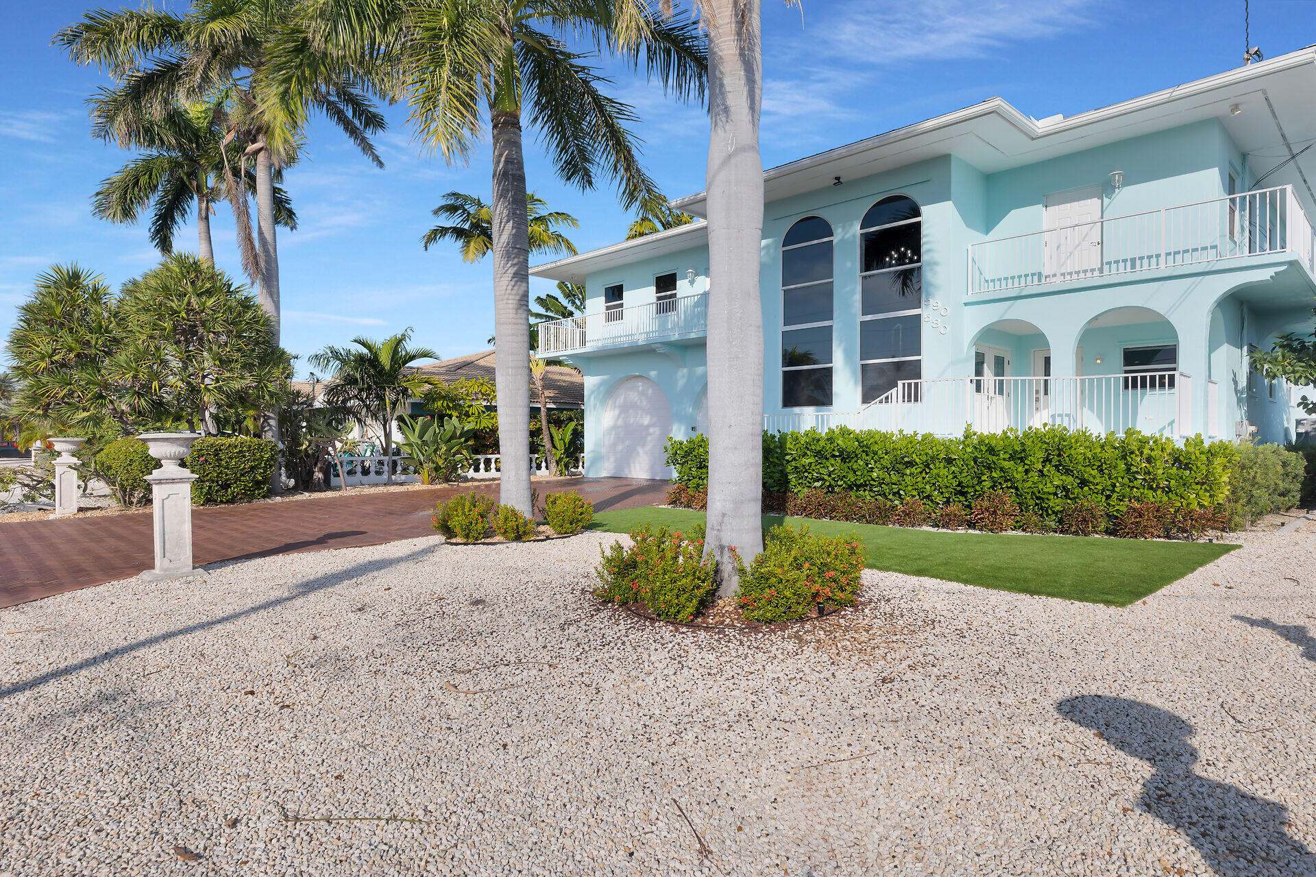 580-590 10th Street Key Colony Beach, FL 33051 - Photo 65 of 75 a front view of a house with a yard and trees