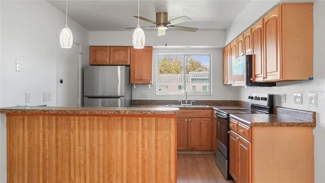 a kitchen with stainless steel appliances granite countertop a sink and a stove