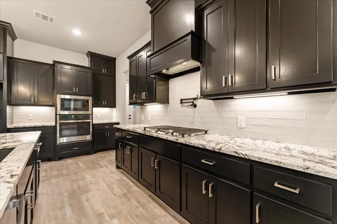 a kitchen with granite countertop stainless steel appliances and sink