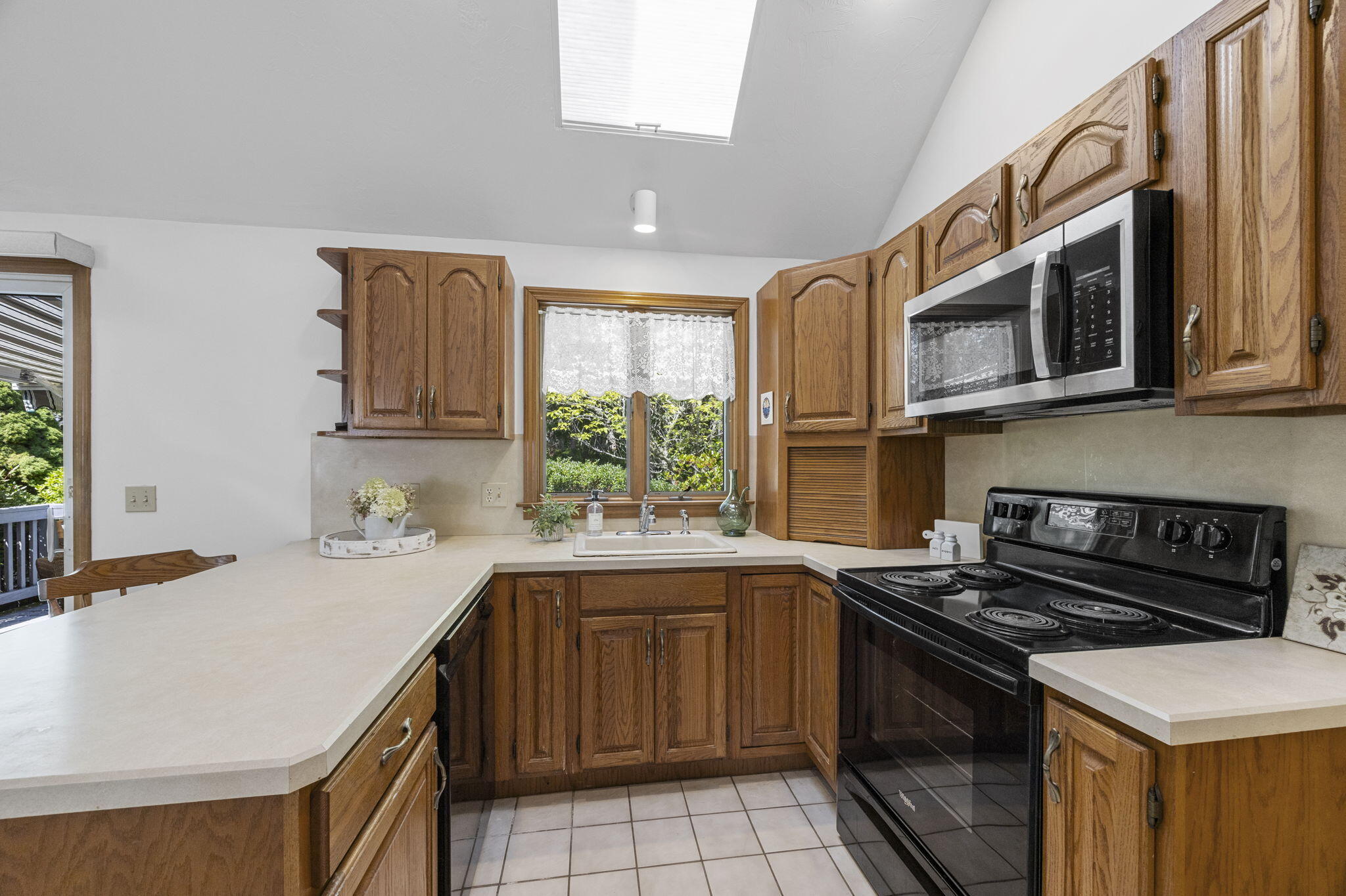 19 Fishermans Landing Road Brewster, MA 02631 - Photo 14 of 58 a kitchen with a sink stove top oven and cabinets
