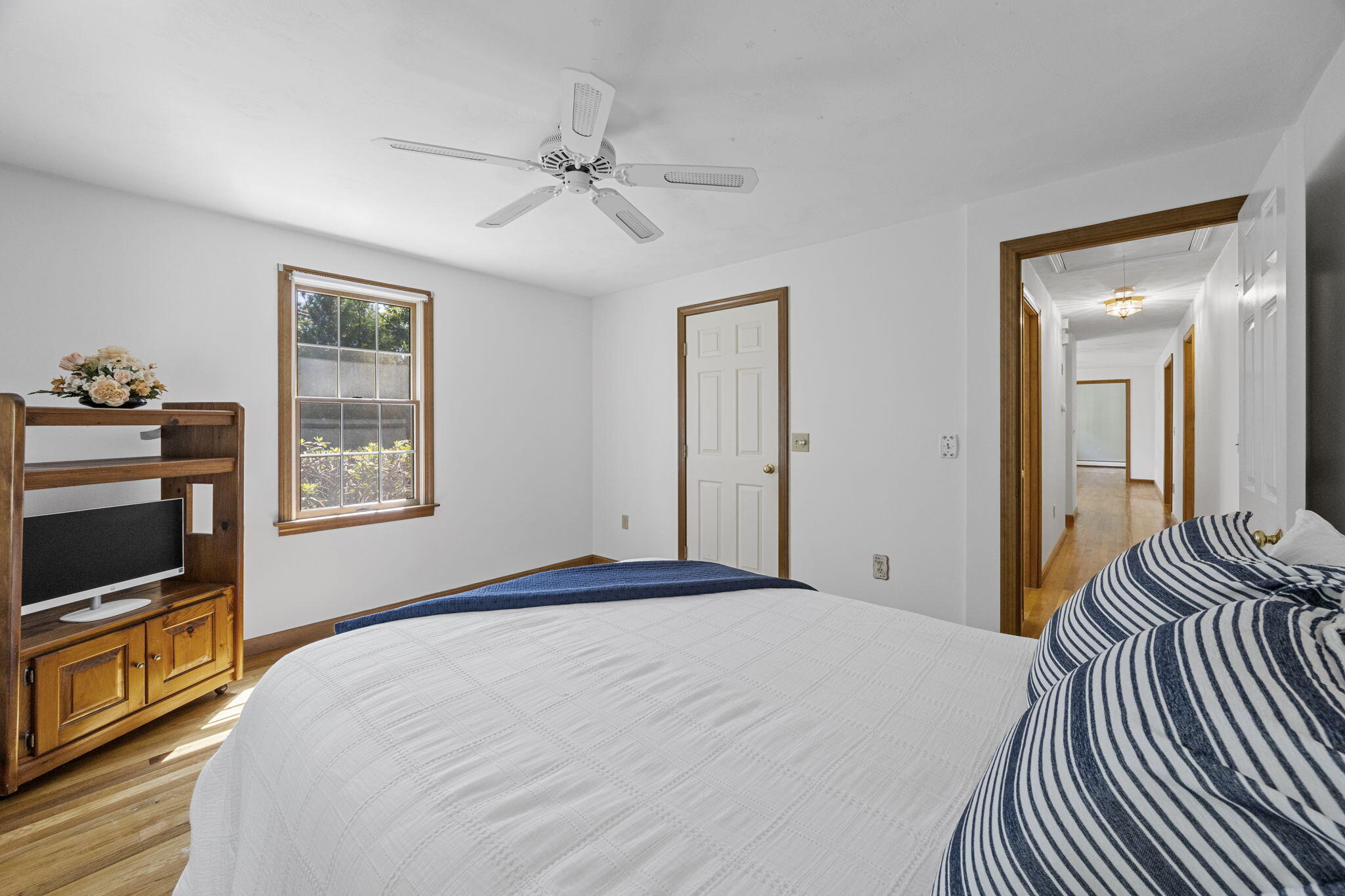 19 Fishermans Landing Road Brewster, MA 02631 - Photo 31 of 58 a bedroom with a bed and a chandelier