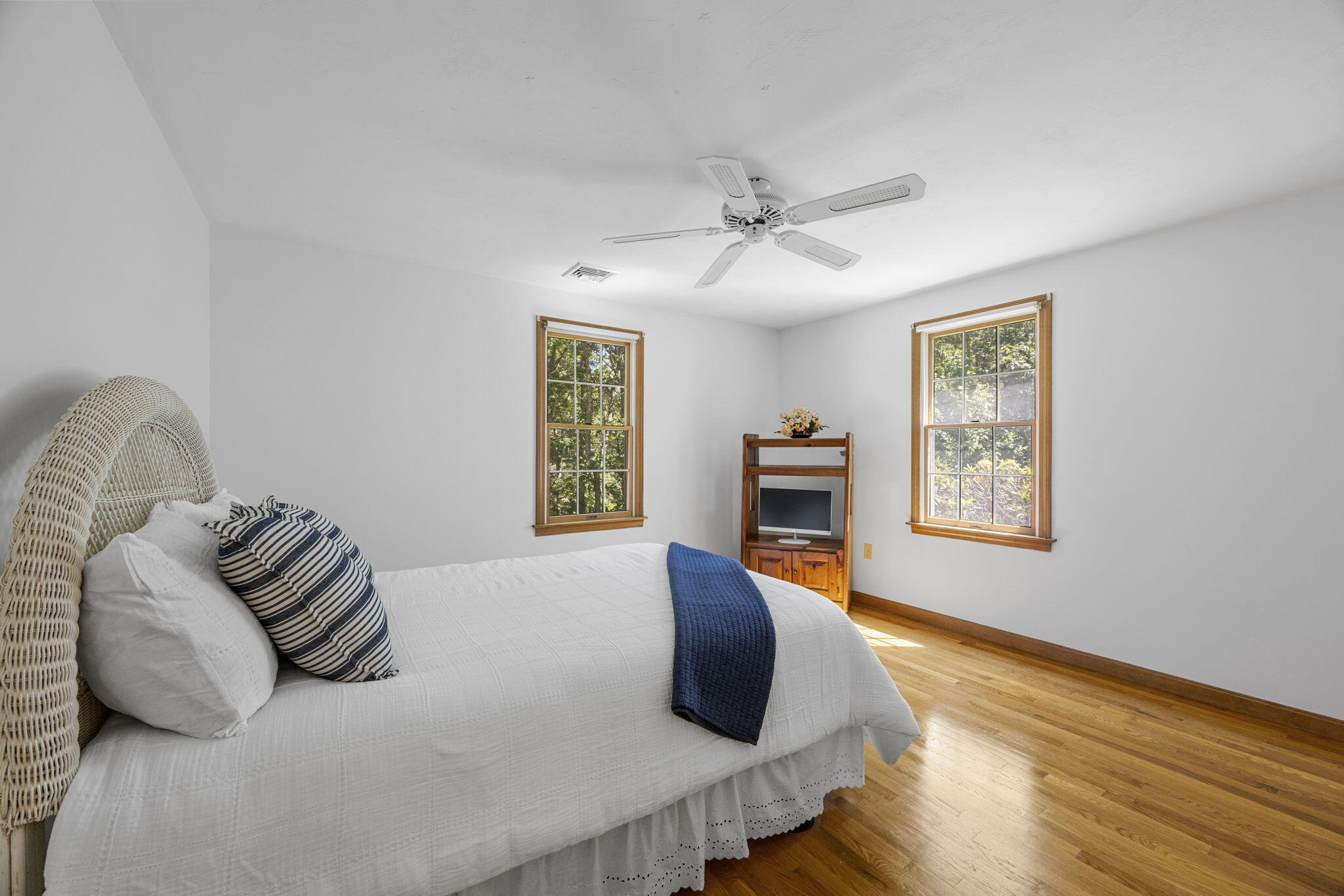 19 Fishermans Landing Road Brewster, MA 02631 - Photo 32 of 58 a bedroom with a bed and wooden floor