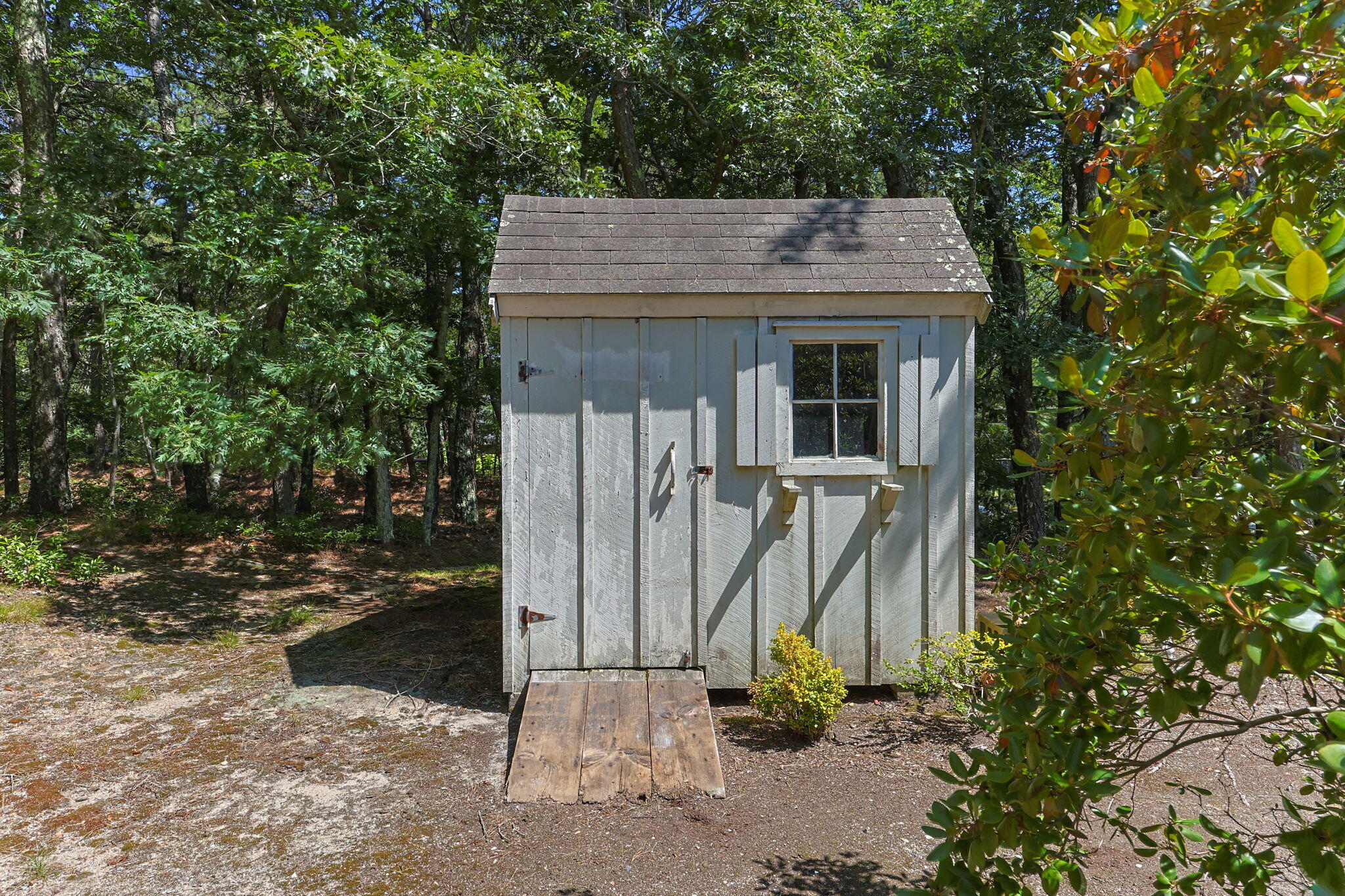 19 Fishermans Landing Road Brewster, MA 02631 - Photo 50 of 58 a view of a wooden house with a small yard and large trees