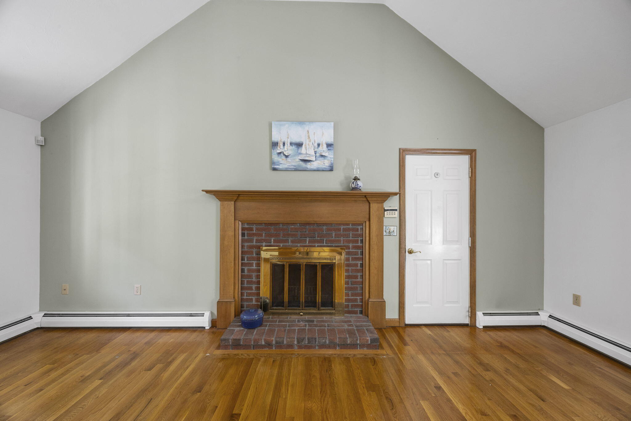 19 Fishermans Landing Road Brewster, MA 02631 - Photo 8 of 58 an empty room with wooden floor and fireplace