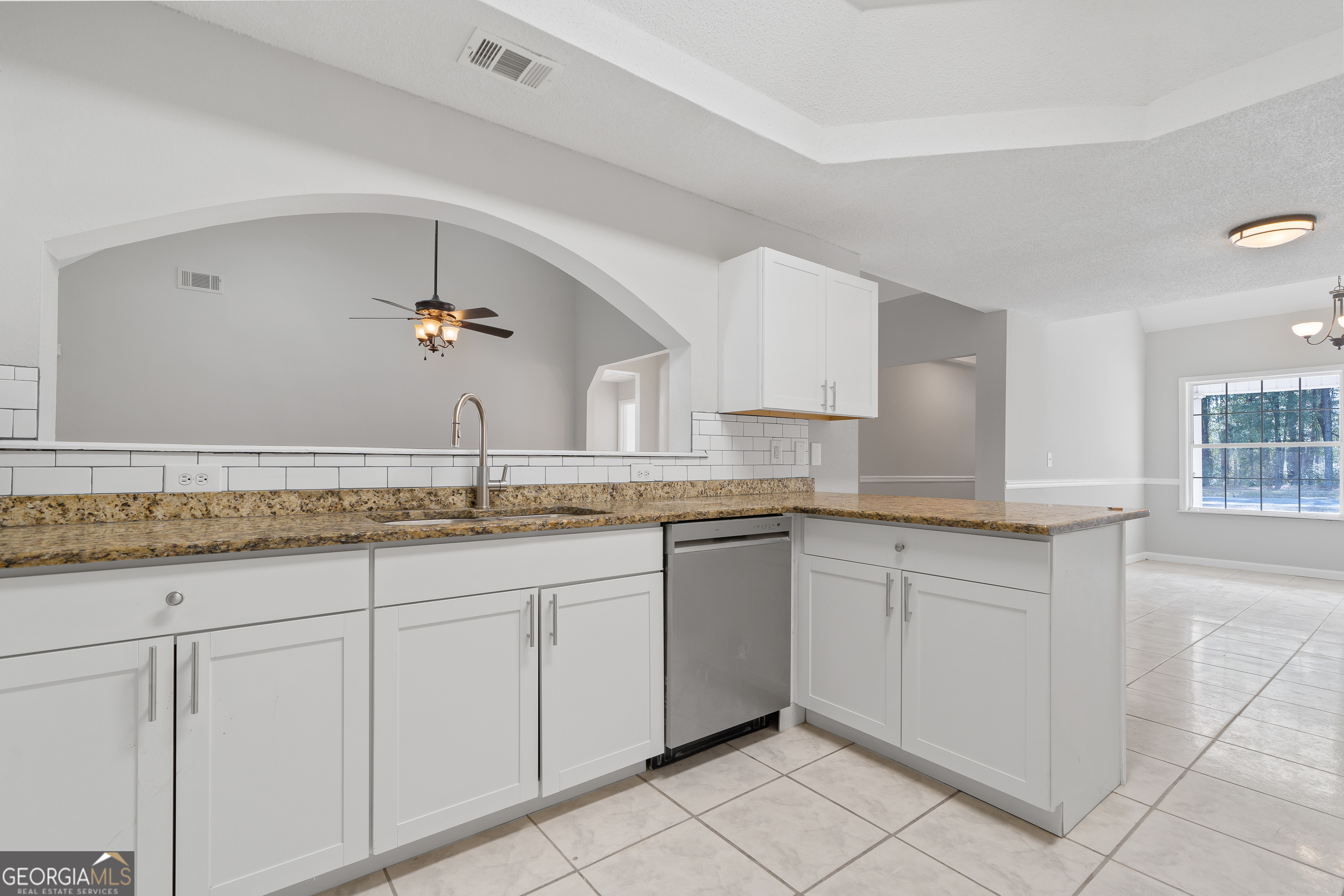 7513 Columbus Road Lizella, GA 31052 - Photo 12 of 54 a bathroom with a granite countertop sink and white cabinets