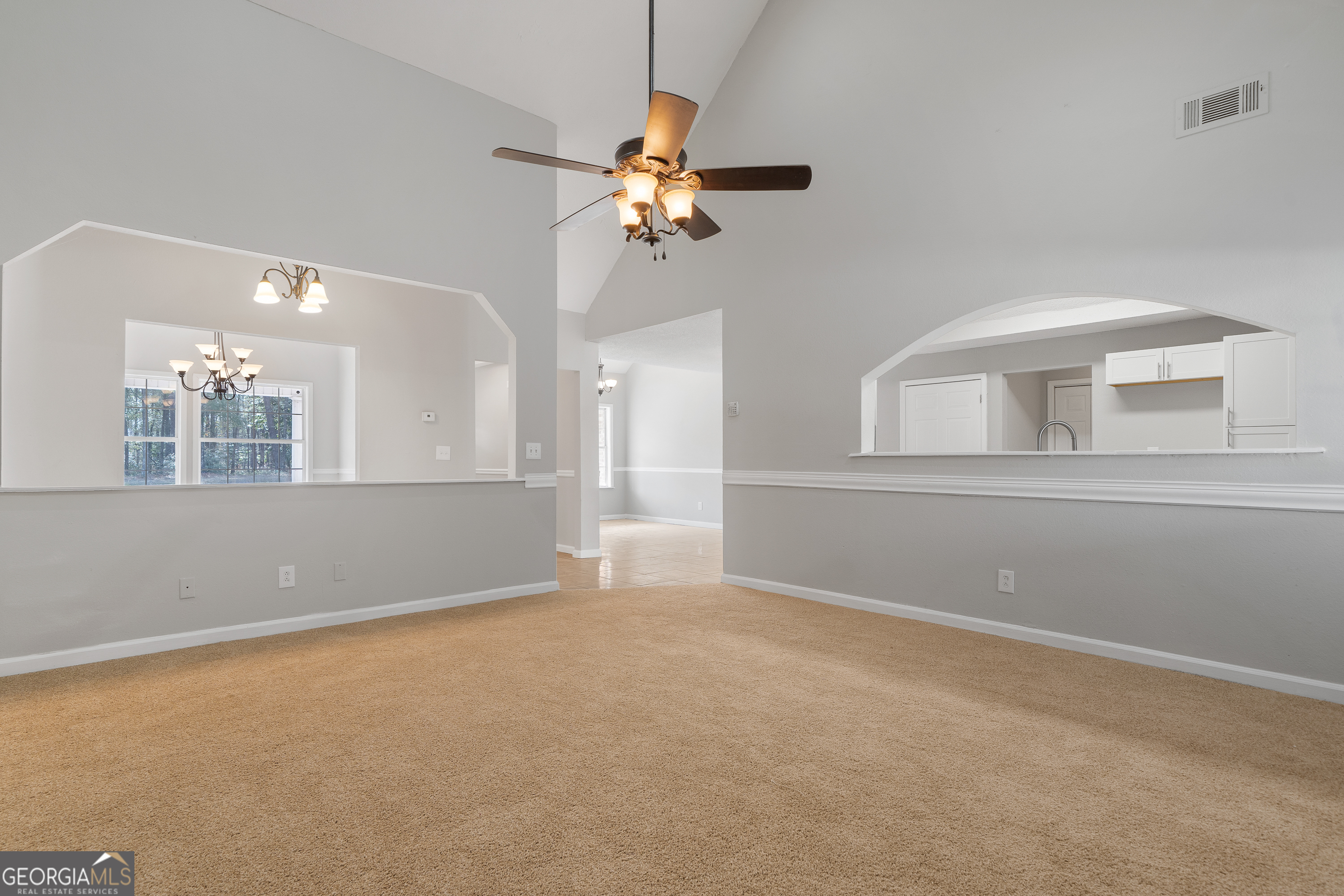 7513 Columbus Road Lizella, GA 31052 - Photo 16 of 54 a view of wooden floor and a chandelier fan in a room