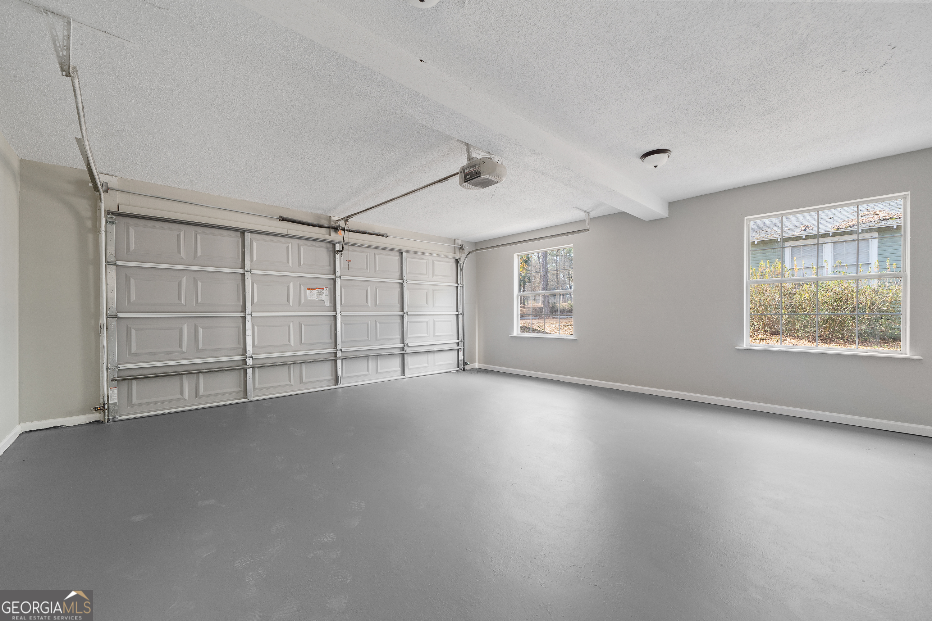 7513 Columbus Road Lizella, GA 31052 - Photo 24 of 54 an empty room with chandelier fan and windows
