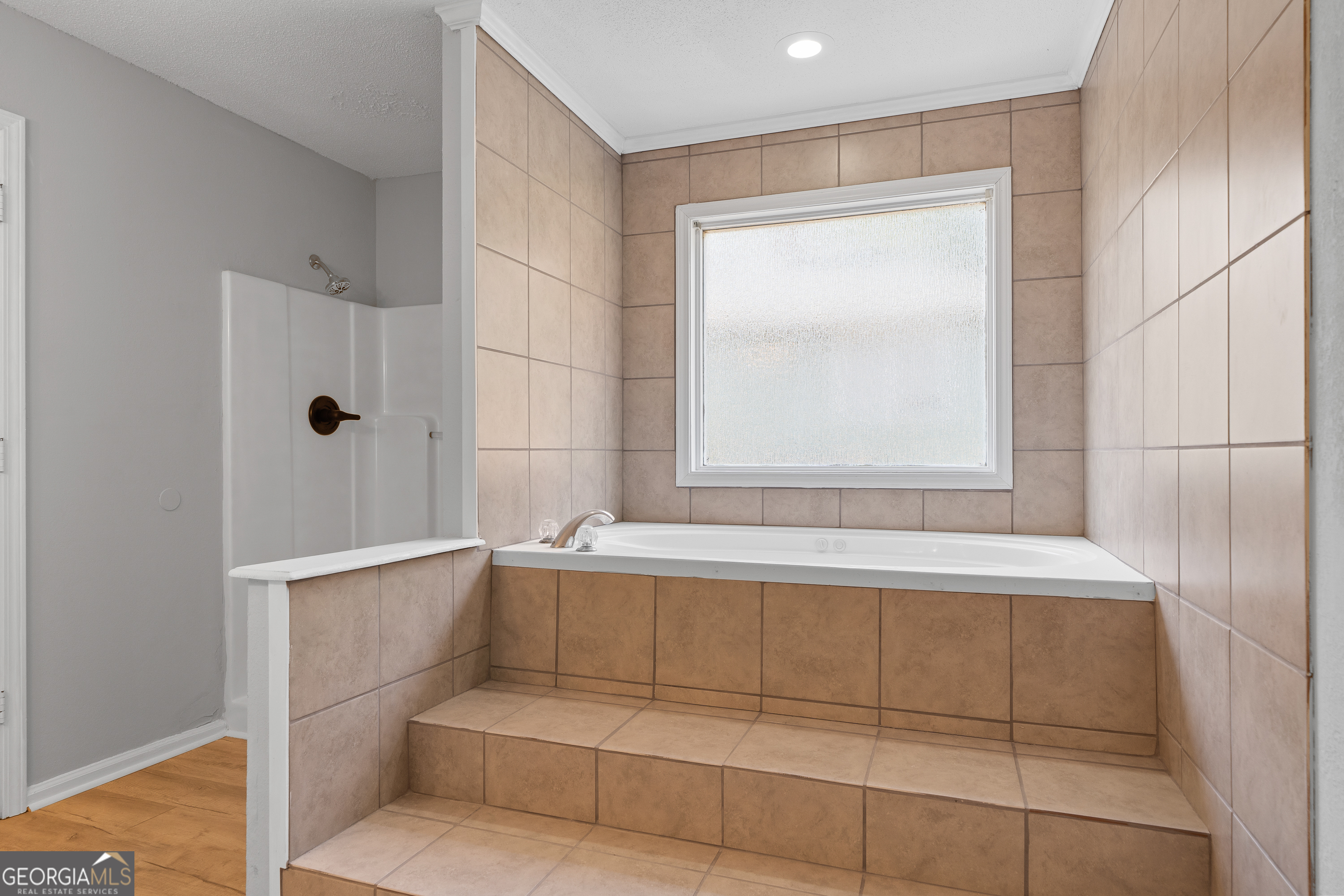 7513 Columbus Road Lizella, GA 31052 - Photo 33 of 54 a bathroom with a bathtub and shower
