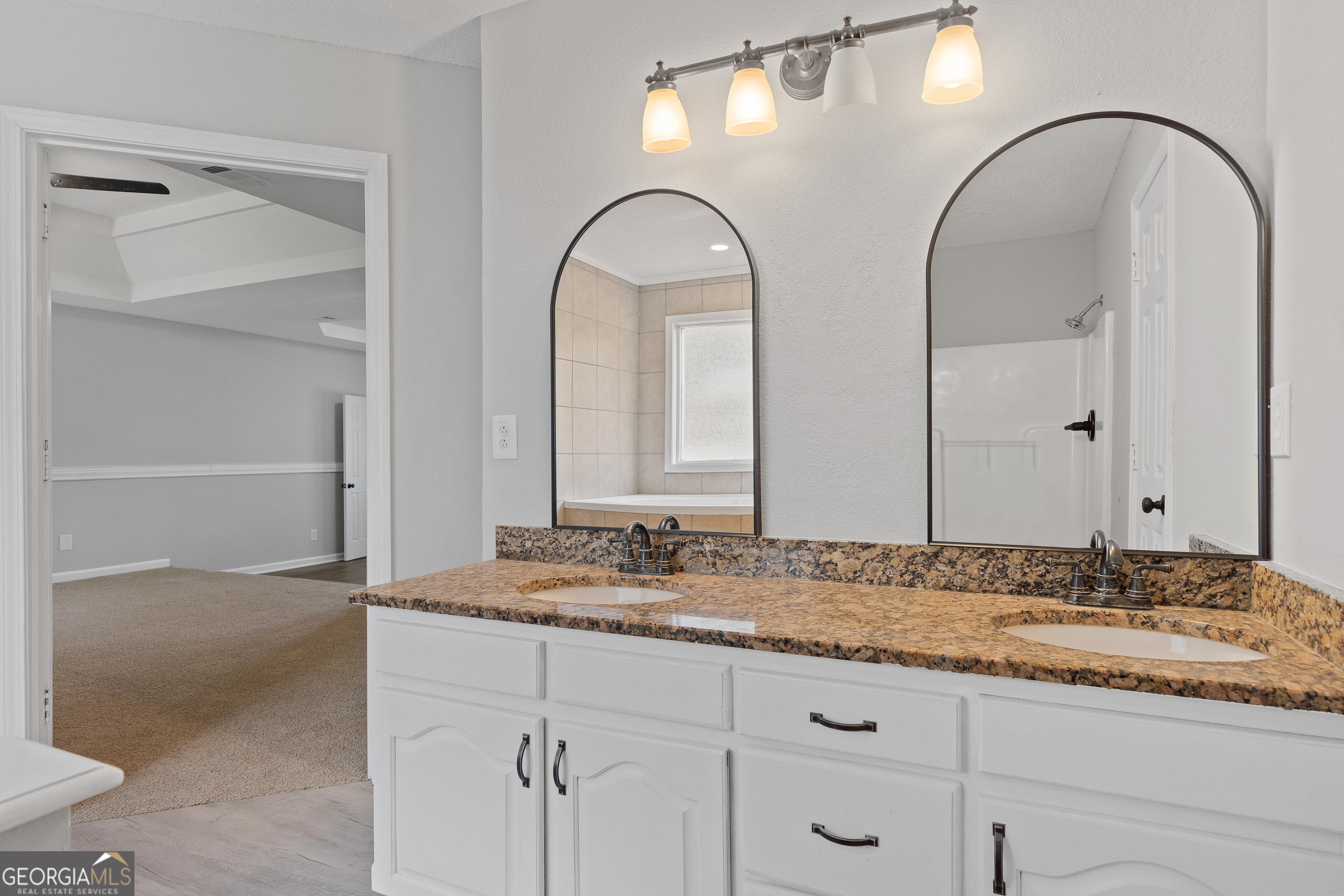 7513 Columbus Road Lizella, GA 31052 - Photo 34 of 54 a bathroom with a granite countertop sink a mirror and shower