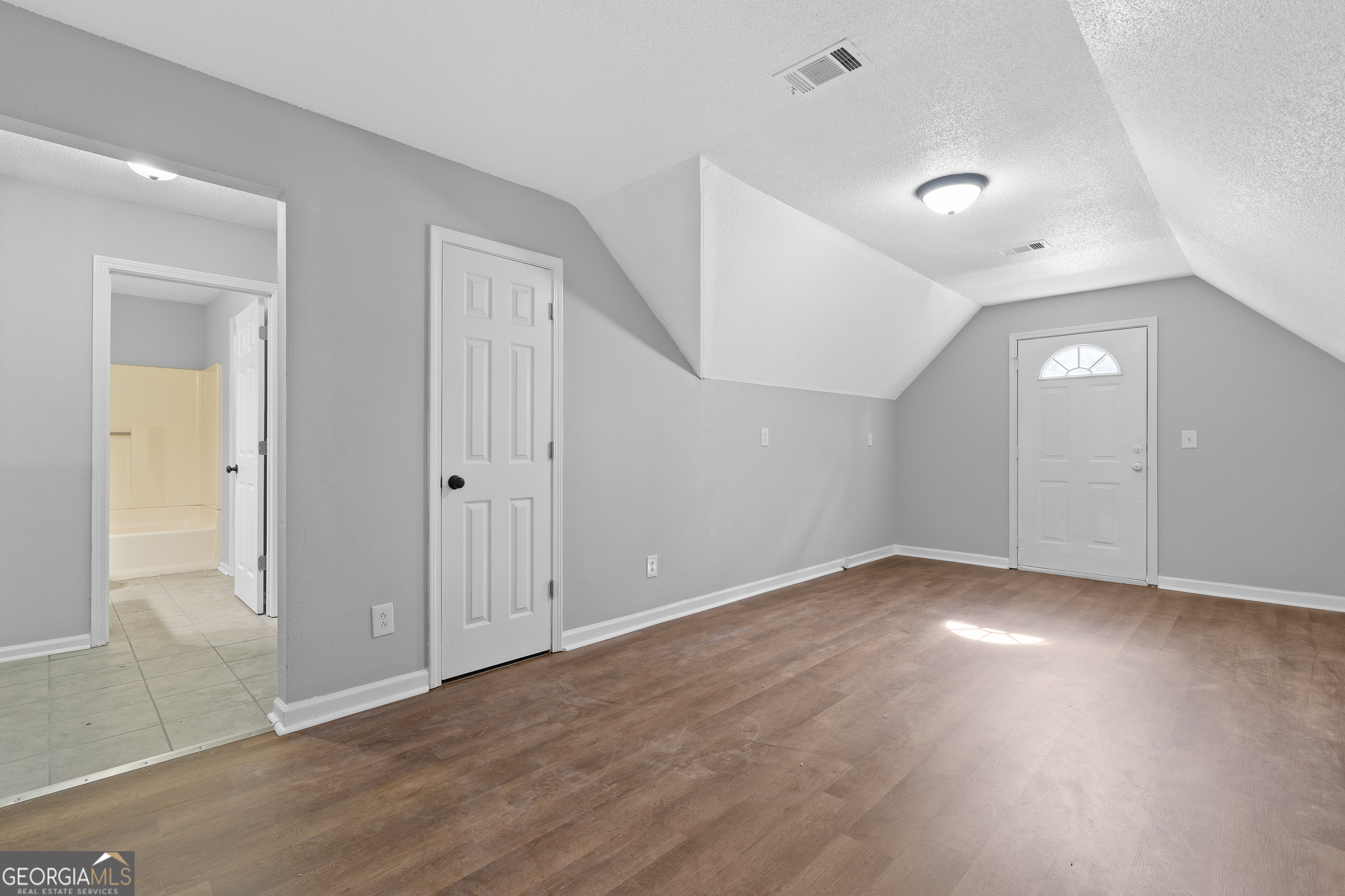7513 Columbus Road Lizella, GA 31052 - Photo 45 of 54 an empty room with wooden floor and windows