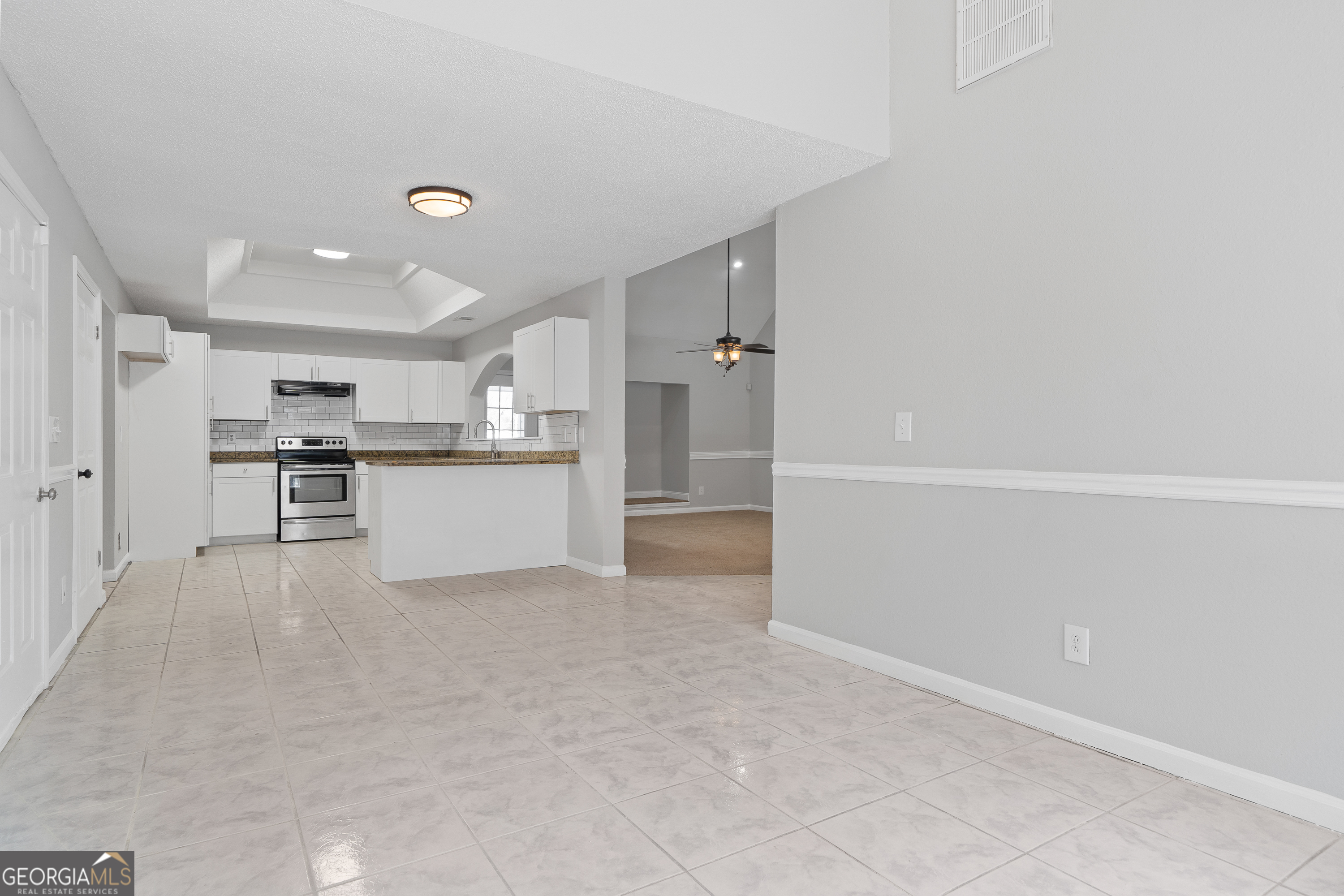 7513 Columbus Road Lizella, GA 31052 - Photo 6 of 54 a view of a kitchen with refrigerator and white cabinets
