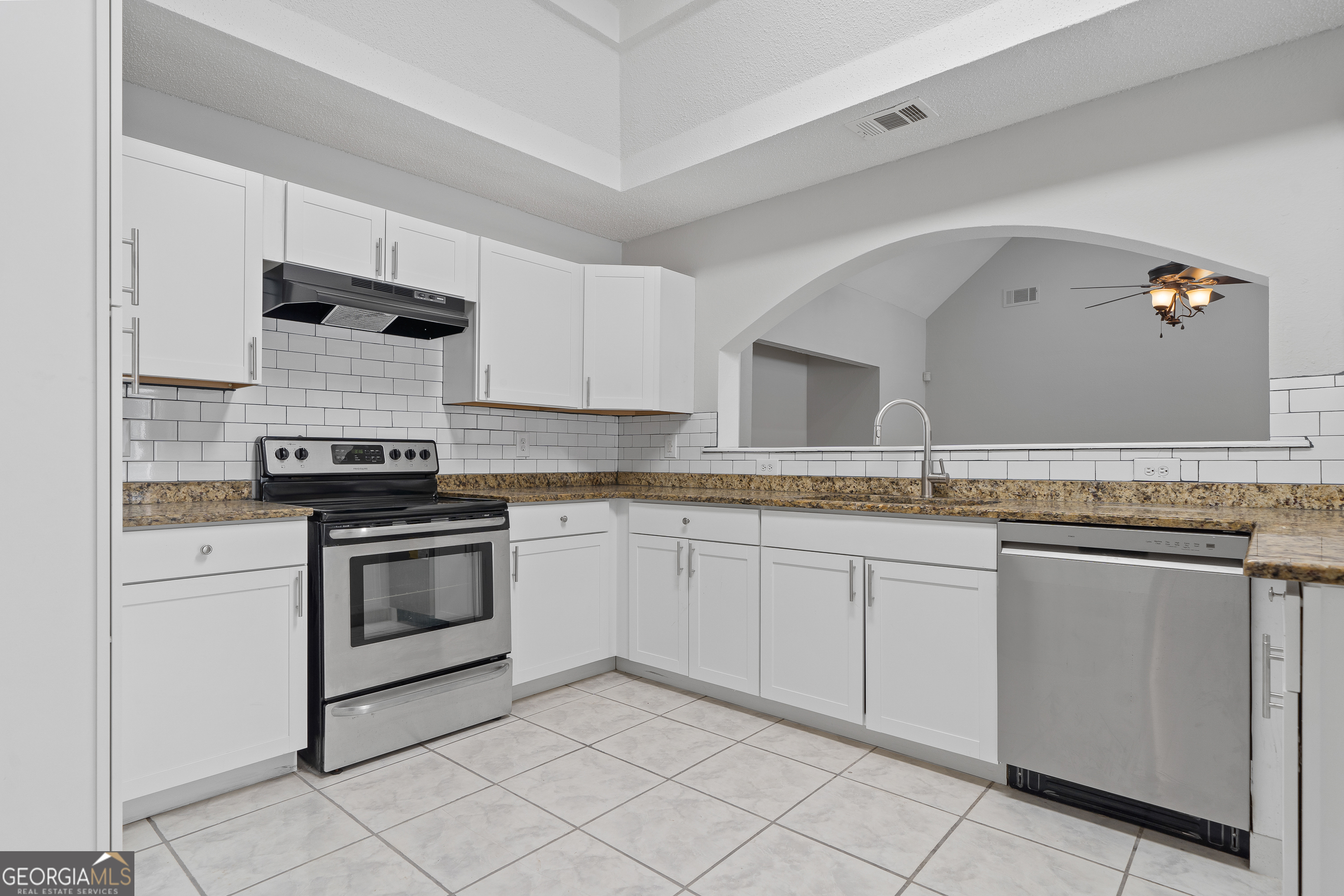 7513 Columbus Road Lizella, GA 31052 - Photo 8 of 54 a kitchen with granite countertop white cabinets and white appliances