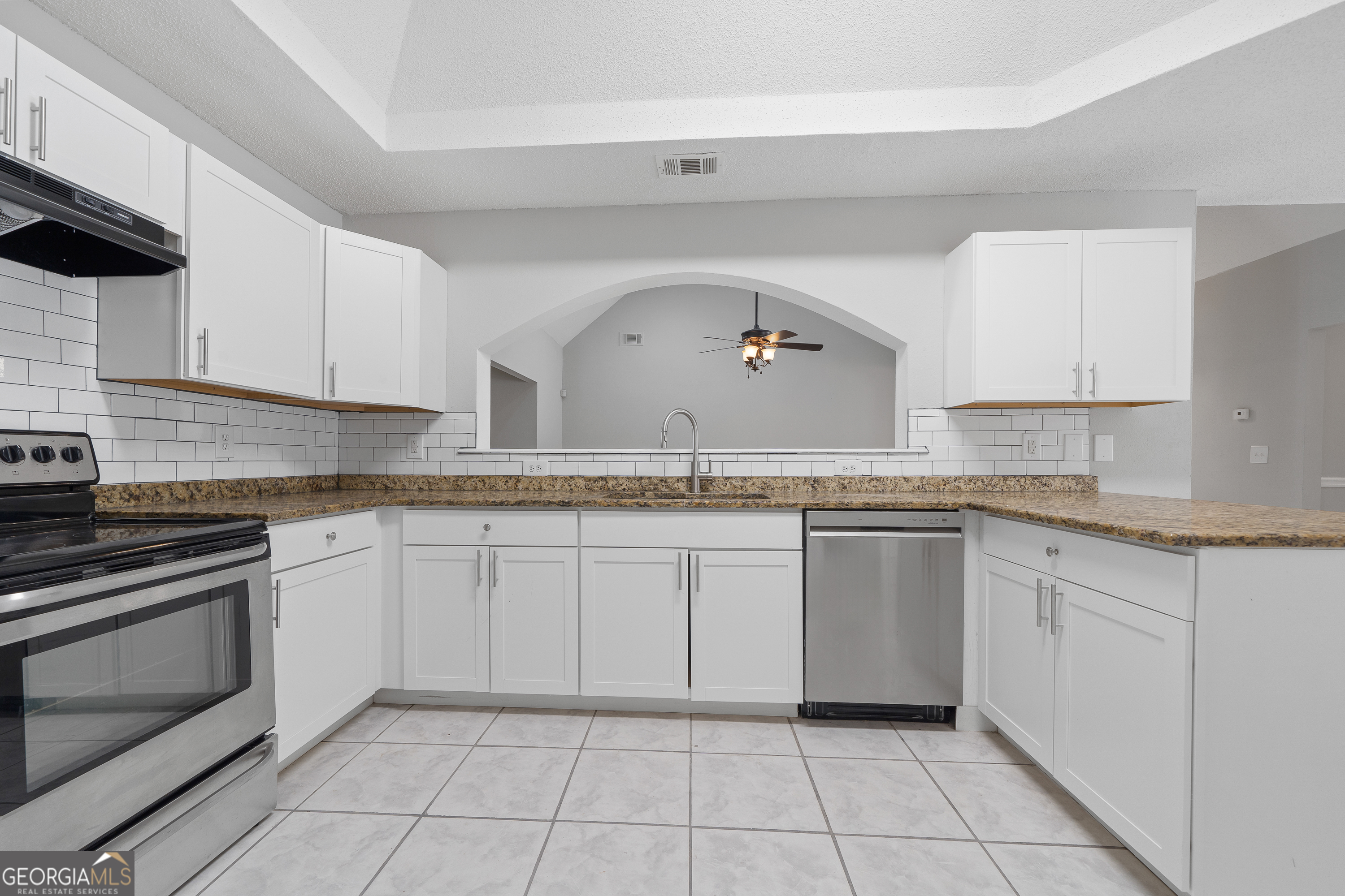 7513 Columbus Road Lizella, GA 31052 - Photo 9 of 54 a kitchen with granite countertop white cabinets and white appliances