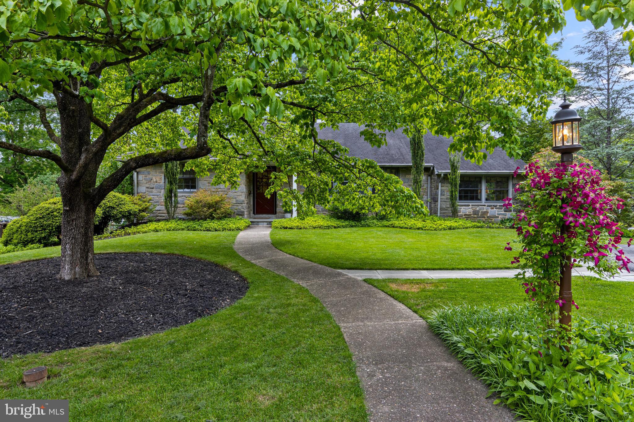 413 Hawthorne Road Wallingford, PA 19086 - Photo 1 of 52 a view of a house with a garden