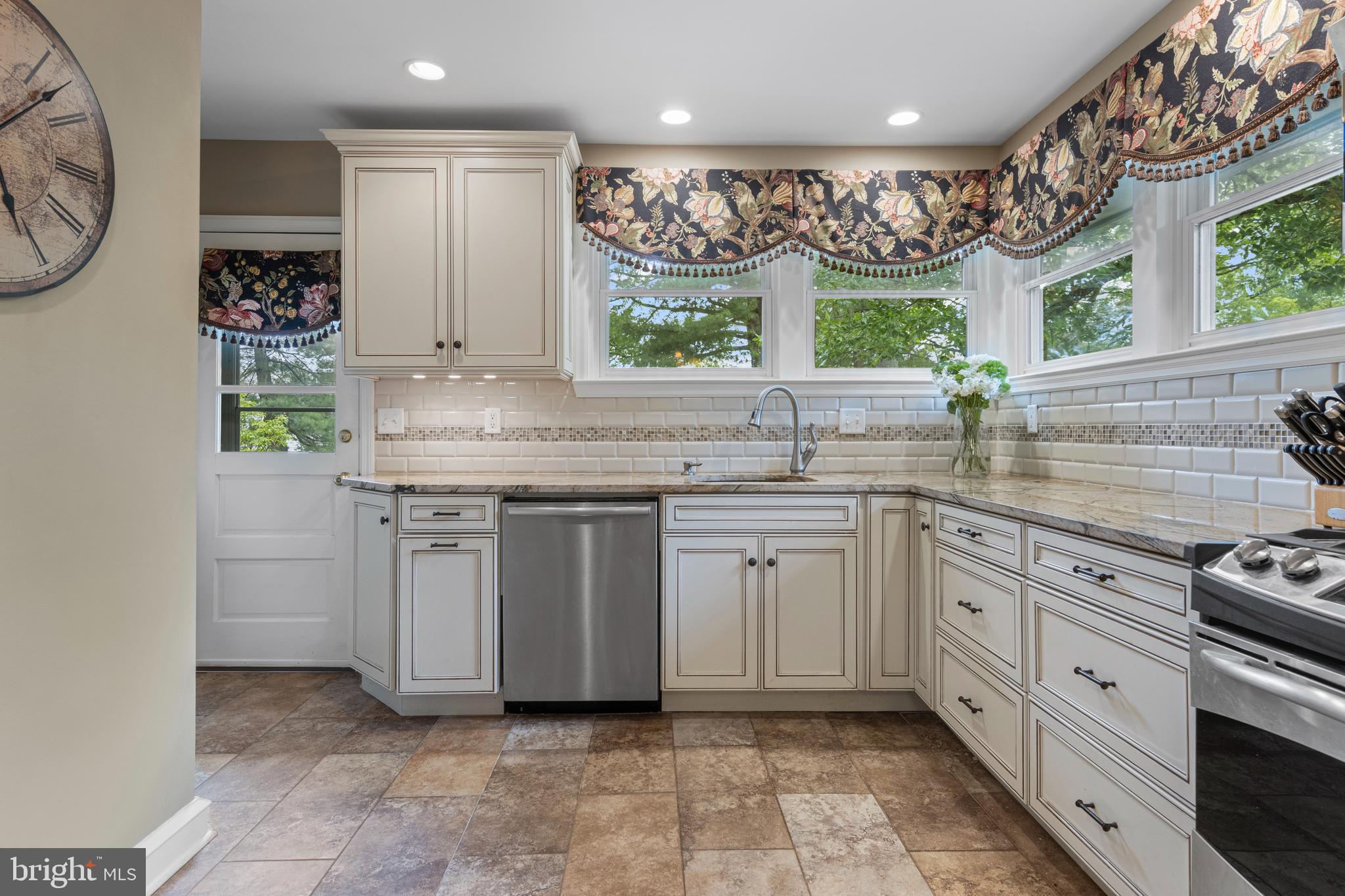 413 Hawthorne Road Wallingford, PA 19086 - Photo 22 of 52 a kitchen with stainless steel appliances granite countertop a sink and a stove