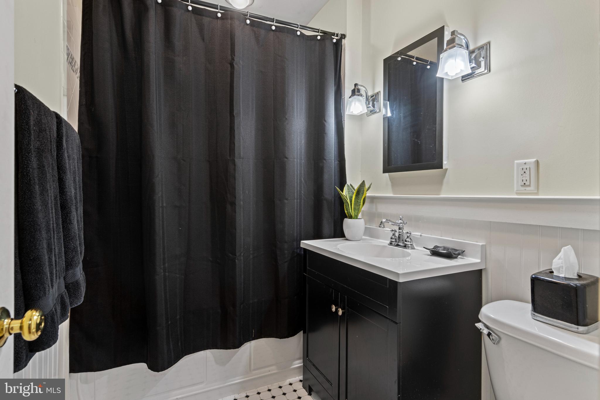 413 Hawthorne Road Wallingford, PA 19086 - Photo 31 of 52 a bathroom with sink a mirror a toilet and vanity